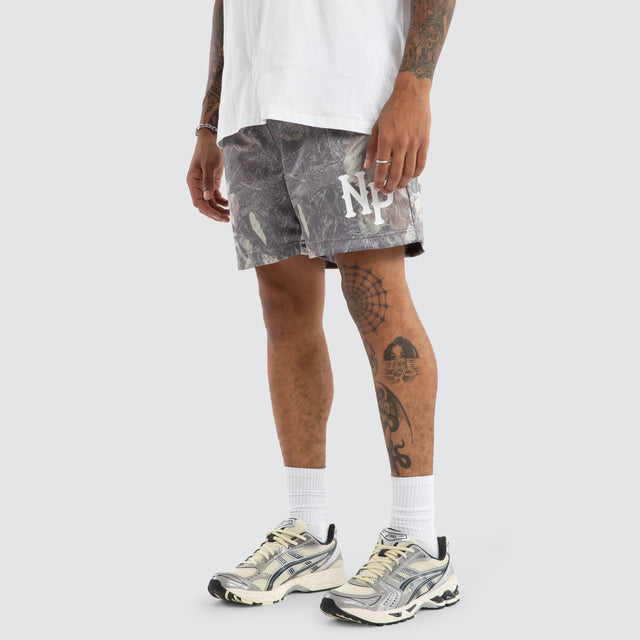 Model wears Carved Camo Mesh Trackshort Camo Shorts in Camo - Image 1