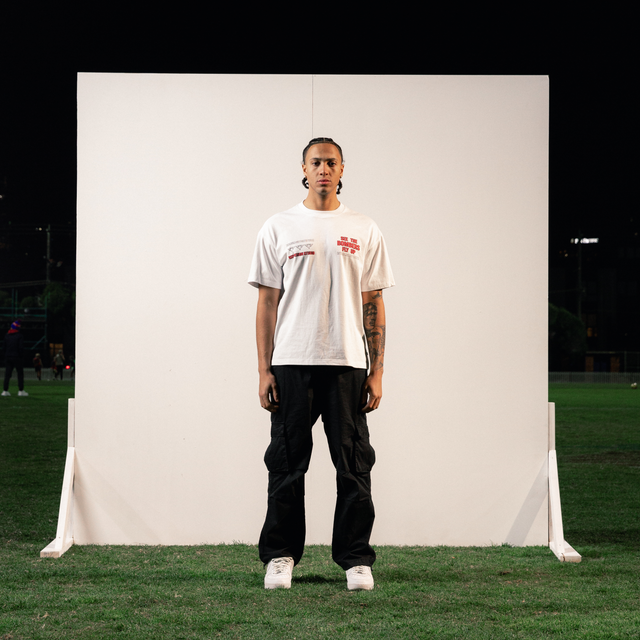 Model Wears Essendon Bombers AFL Heavy Raptor Tee Optical White T-Shirts in White - Image 2