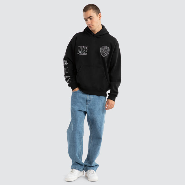 Model Wears Richmond Tigers AFL Mono Hoodie Jet Black Hoodies in Black - Image 4