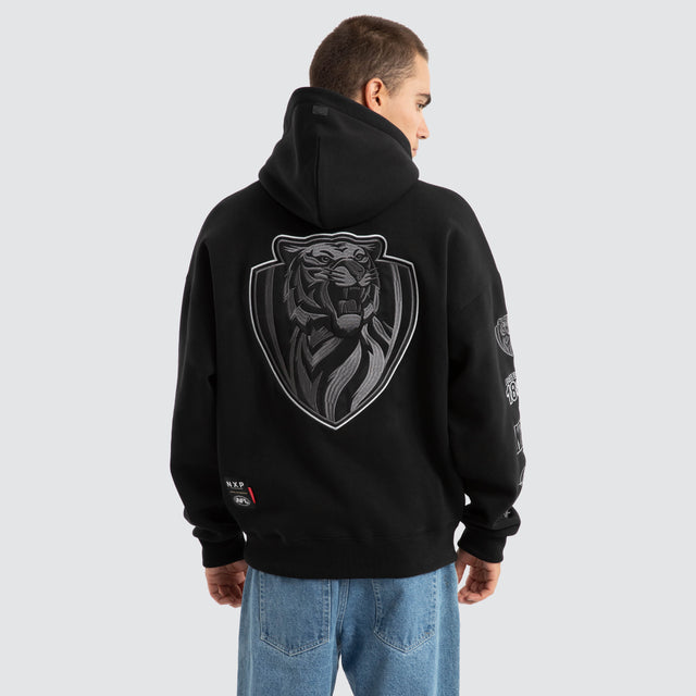 Model Wears Richmond Tigers AFL Mono Hoodie Jet Black Hoodies in Black - Image 1