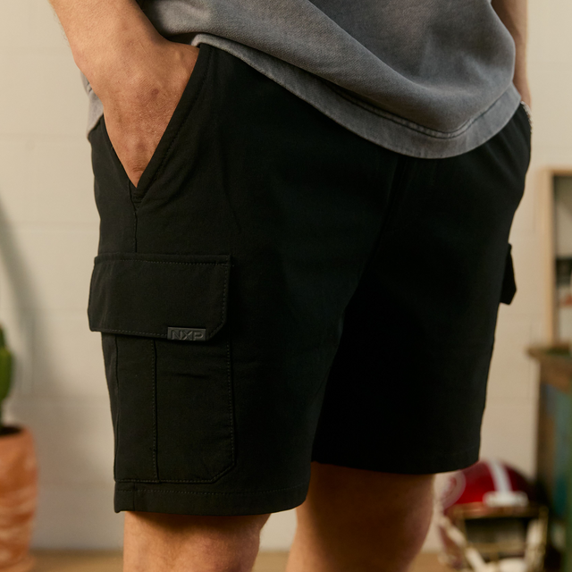 Model Wears S150 Slim Stretch Cargo Short Black Shorts in Black - Image 2