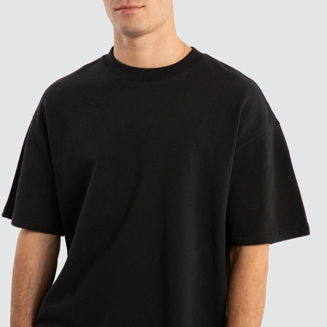 Model Wears Supply Loopback Raptor Tee Jet Black T-Shirts in Black - Image 3