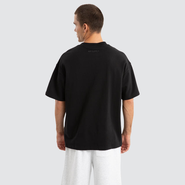 Model Wears Supply Loopback Raptor Tee Jet Black T-Shirts in Black - Image 4