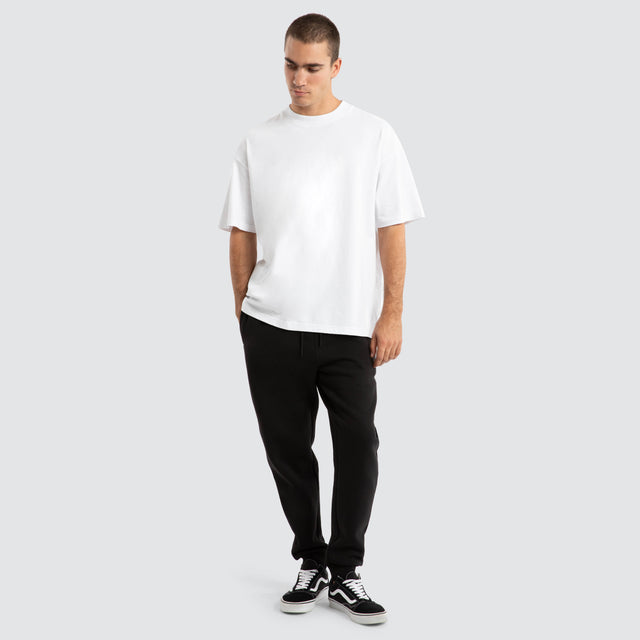 Model Wears Supply Skinny Trackpant Jet Black Trackpants in Black - Image 2