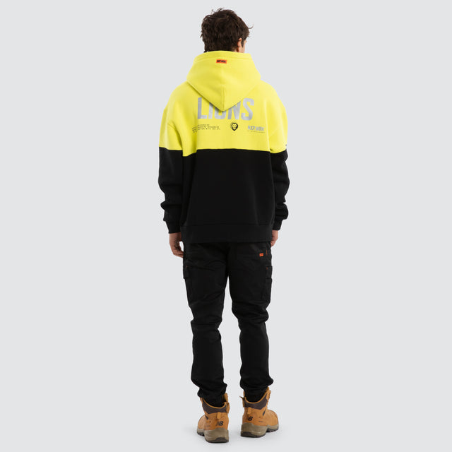 Model wears Brisbane Lions Block Hoodie Yellow Black Hoodies in Yellow - Image 4