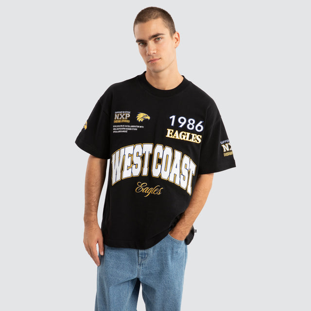 Model Wears West Coast Eagles AFL Academy Tee Jet Black T-Shirts in Black - Image 1