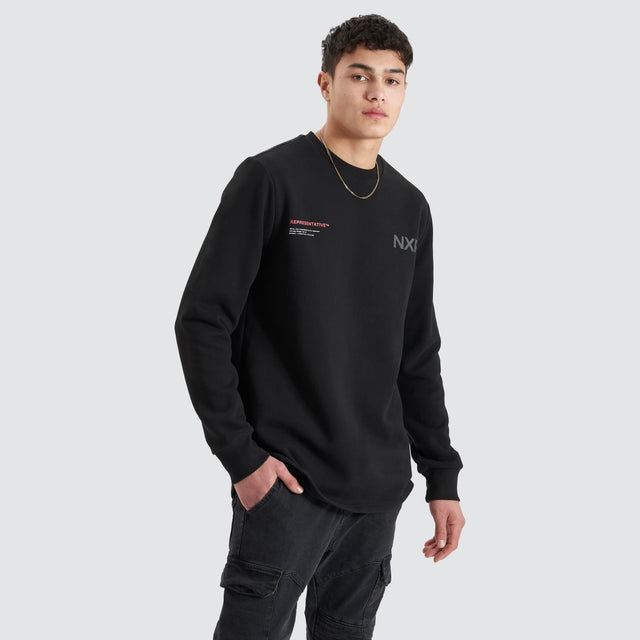 Model Wears Adjacent Dual Curved Sweater Jet Black Jumpers in Black - Image 3