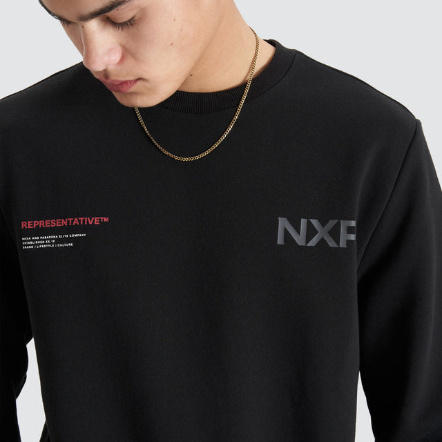 Model Wears Adjacent Dual Curved Sweater Jet Black Jumpers in Black - Image 5