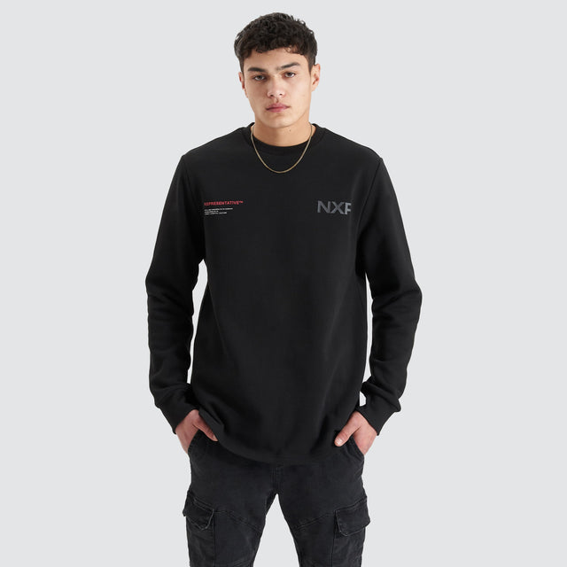 Model Wears Adjacent Dual Curved Sweater Jet Black Jumpers in Black - Image 4