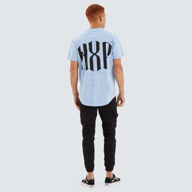 Model Wears Anode Dual Curved Tee Pigment Placid Blue T-Shirts in Blue - Image 5