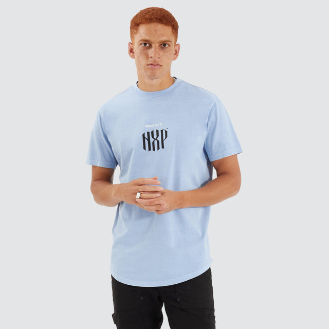 Model Wears Anode Dual Curved Tee Pigment Placid Blue T-Shirts in Blue - Image 1