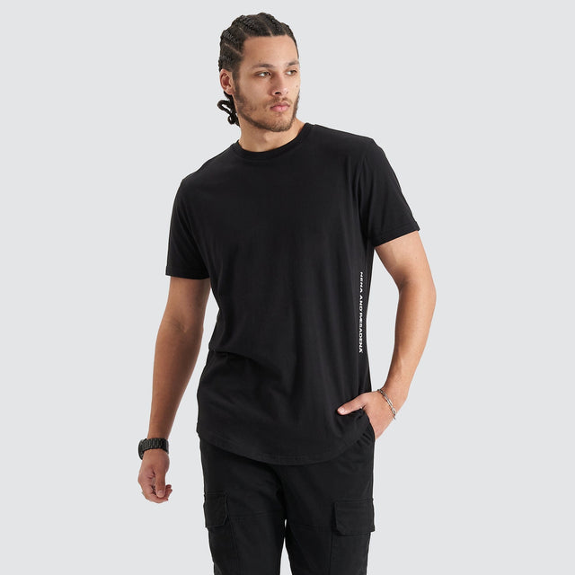Model Wears Back Rank Dual Curved Tee Jet Black T-Shirts in Black - Image 2