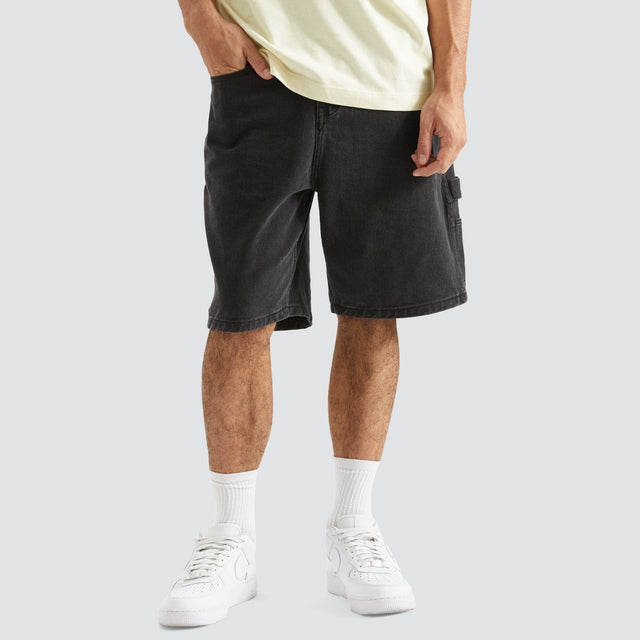 Model Wears Built Carpenter Short Black Shorts in Black - Image 1