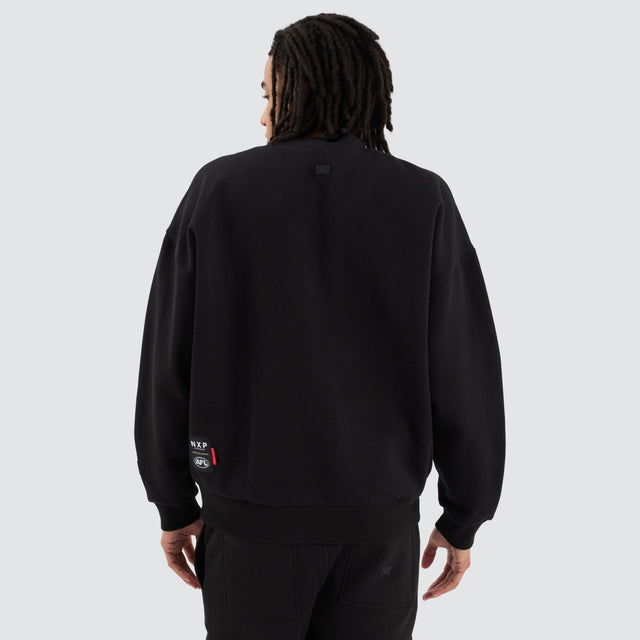 Model Wears Carlton Blues AFL Box Fit Sweater Jet Black Jumpers in Black - Image 4