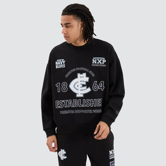Model Wears Carlton Blues AFL Box Fit Sweater Jet Black Jumpers in Black - Image 1