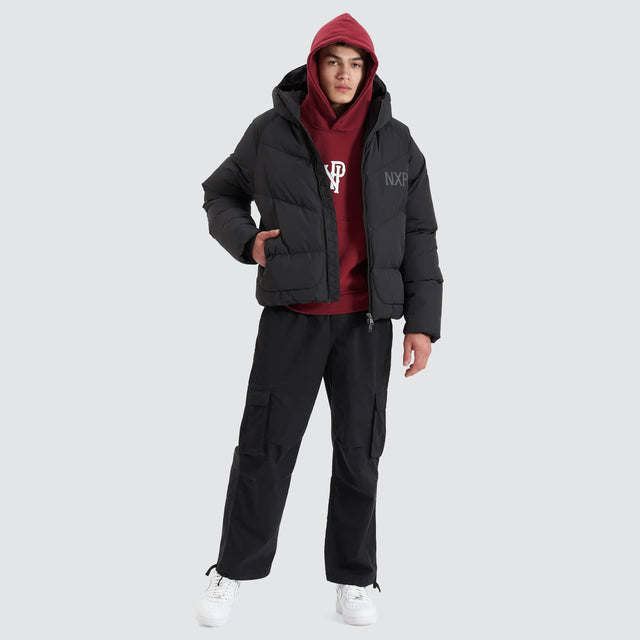Model Wears Chrysler Raglan Puffer Jacket Jet Black Jackets in Black - Image 5