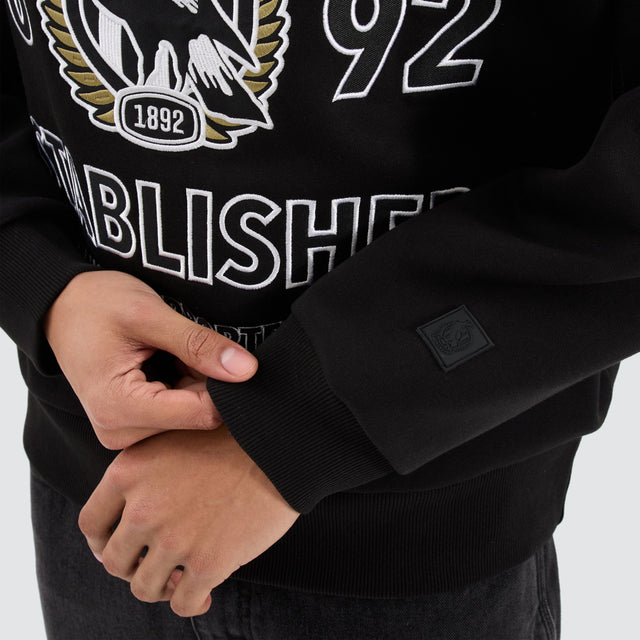 Model Wears Collingwood Magpies AFL Box Fit Sweater Jet Black Jumpers in Black - Image 4