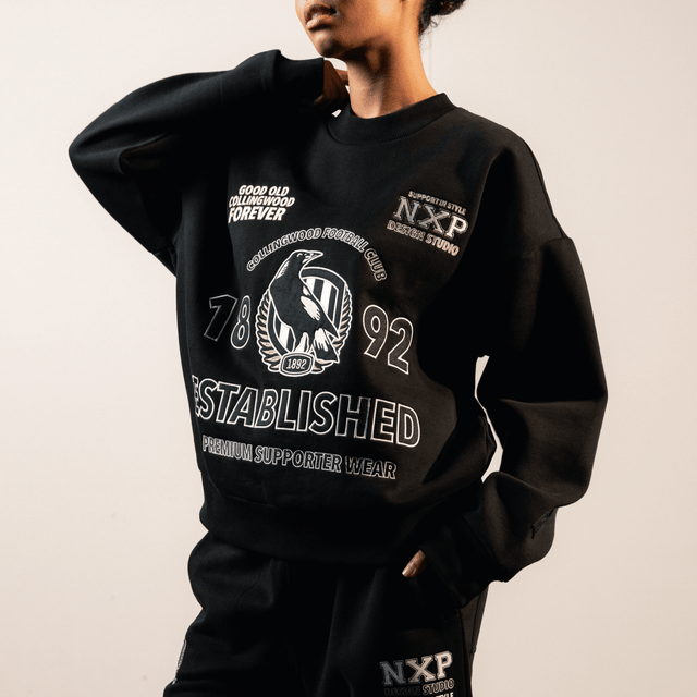 Model Wears Collingwood Magpies AFL Box Fit Sweater Jet Black Jumpers in Black - Image 2