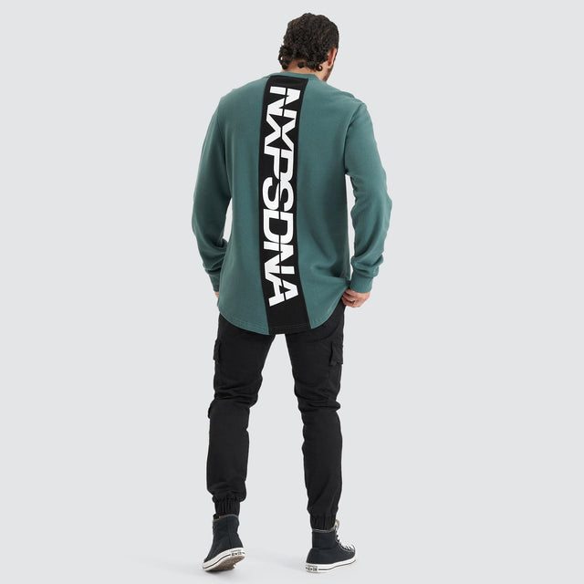 Model Wears Compensation Dual Curved Jumper Silver Pine/Black Jumpers in Green - Image 5