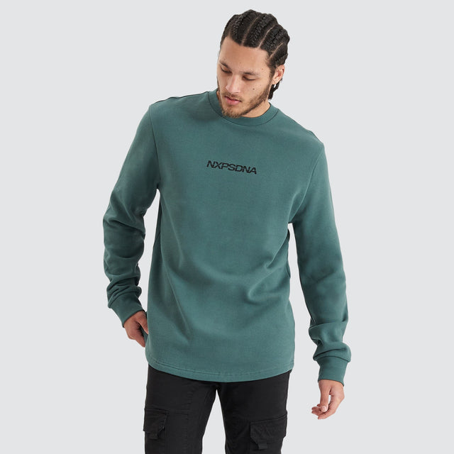 Model Wears Compensation Dual Curved Jumper Silver Pine/Black Jumpers in Green - Image 4