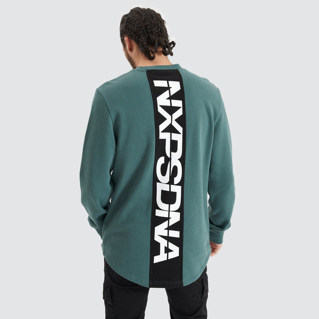 Model Wears Compensation Dual Curved Jumper Silver Pine/Black Jumpers in Green - Image 1