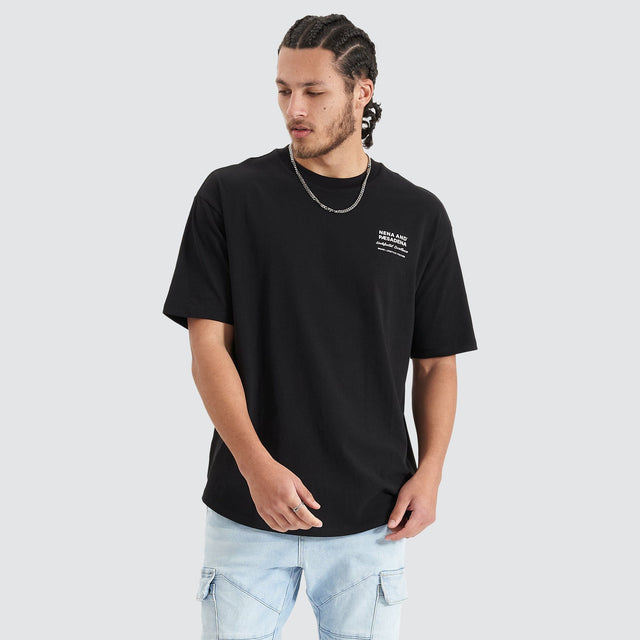 Model Wears Compound Heavy Box Fit Tee Jet Black T-Shirts in Black - Image 1