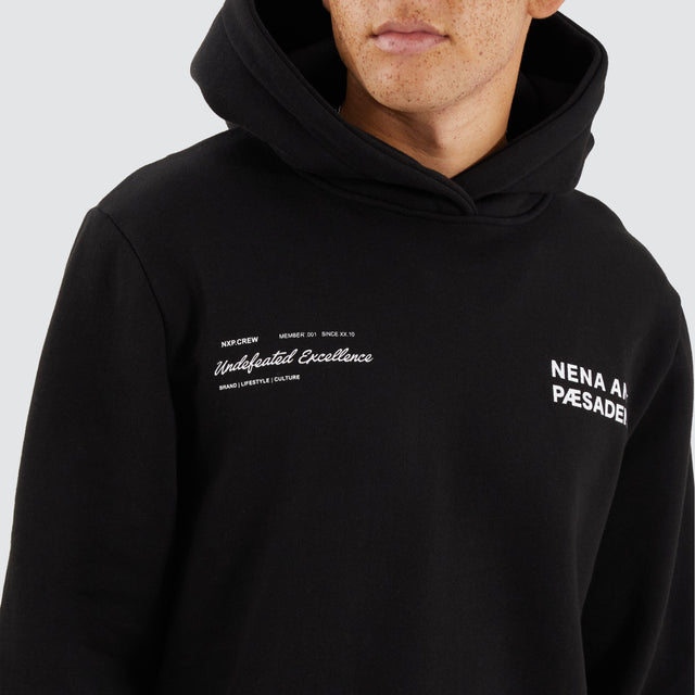 Model Wears Concentric Dual Curved Hoodie Jet Black Hoodies in Black - Image 3
