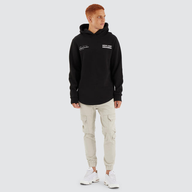 Model Wears Concentric Dual Curved Hoodie Jet Black Hoodies in Black - Image 4