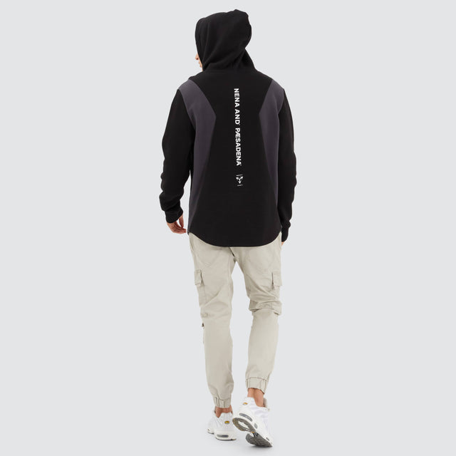 Model Wears Concentric Dual Curved Hoodie Jet Black Hoodies in Black - Image 5