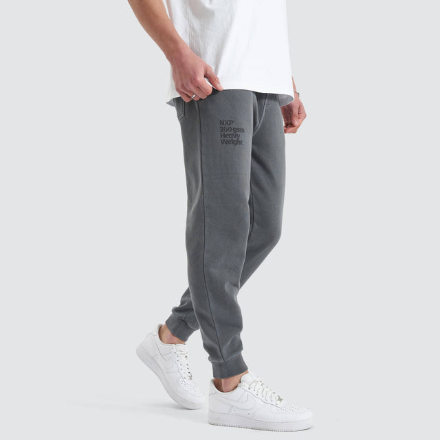 Model Wears Core Line Heavy Trackpant Pigment Charcoal Trackpants in Grey - Image 2