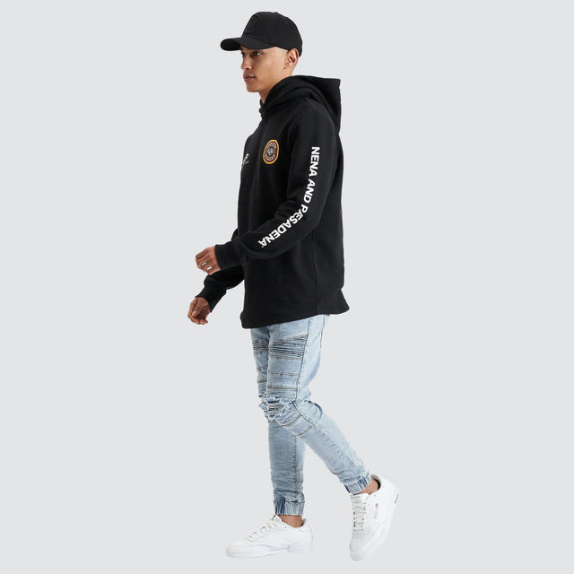 Model Wears Drummond Dual Curved Hoodie Jet Black Hoodies in Black - Image 5