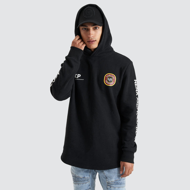 Model Wears Drummond Dual Curved Hoodie Jet Black Hoodies in Black - Image 8