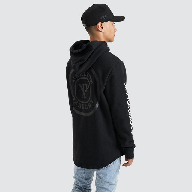 Model Wears Drummond Dual Curved Hoodie Jet Black Hoodies in Black - Image 6
