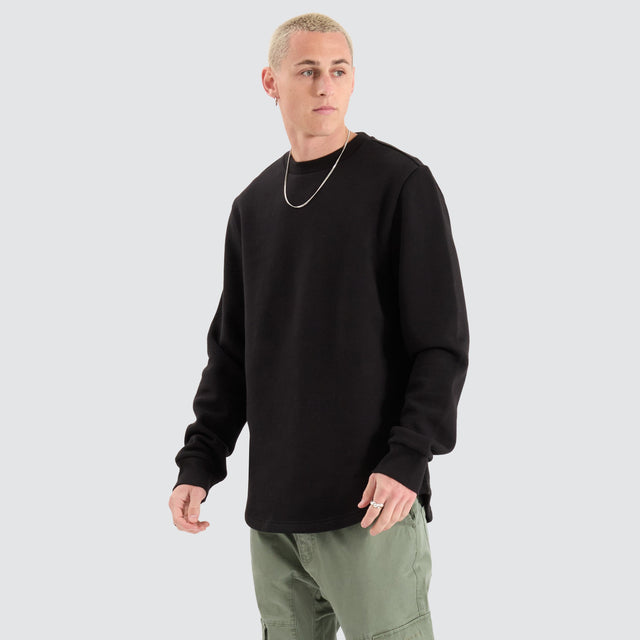 Model Wears Fernie Dual Curved Sweater Jet Black Jumpers in Black - Image 1