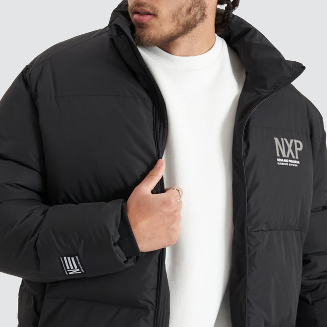 Model Wears Forfeit Puffer Jacket Jet Black Jackets in Black - Image 4