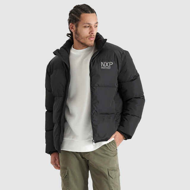 Model Wears Forfeit Puffer Jacket Jet Black Jackets in Black - Image 1