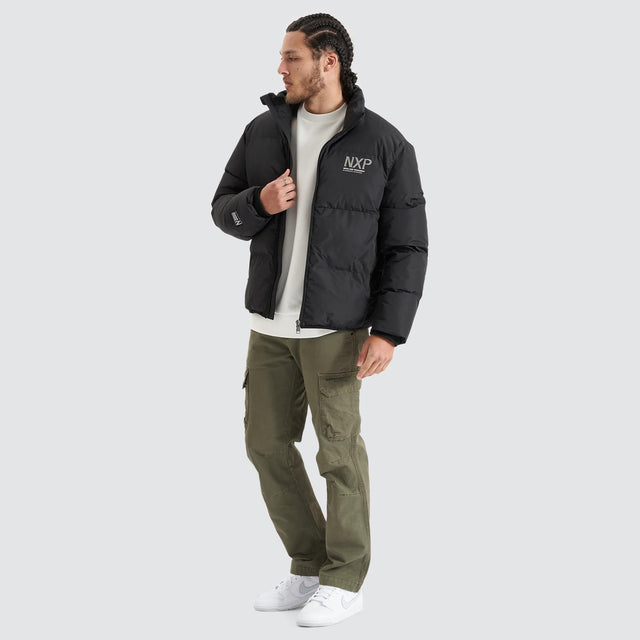 Model Wears Forfeit Puffer Jacket Jet Black Jackets in Black - Image 3