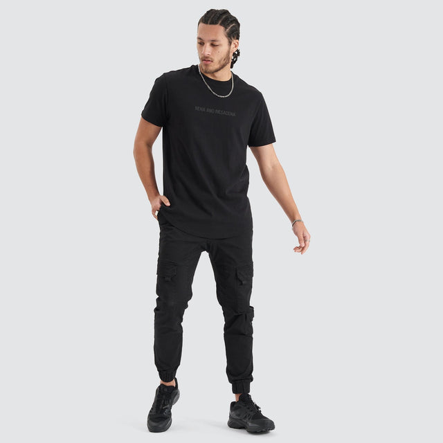 Model Wears Friction Dual Curved Tee Jet Black T-Shirts in Black - Image 5