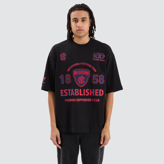 Model Wears Melbourne Demons AFL Mega Loopback Tee Jet Black T-Shirts in Black - Image 1