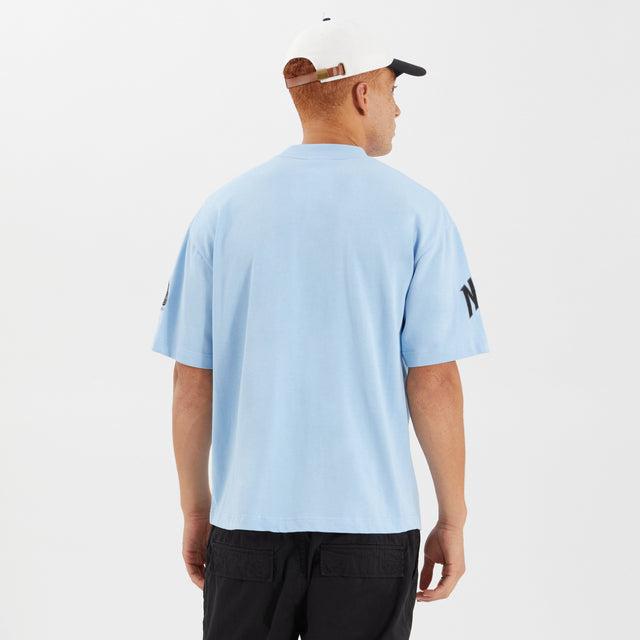 Model Wears Members Loopback Street Tee Placid Blue T-Shirts in Blue - Image 3