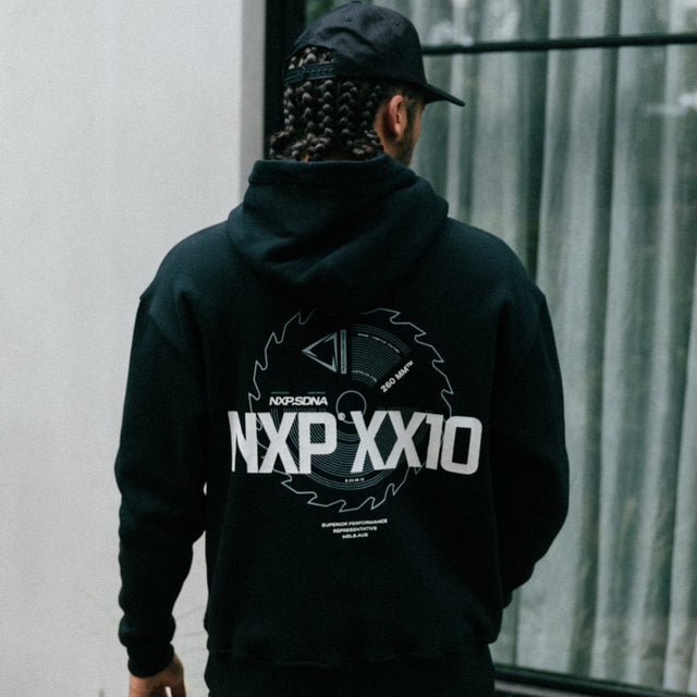 Model Wears Mortar Heavy Relaxed Hoodie Jet Black Jumpers in Black - Image 2