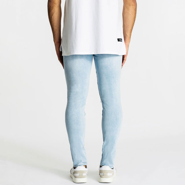Model Wears Combination Jean 2.0 Canyon Blue Pants in Blue - Image 3