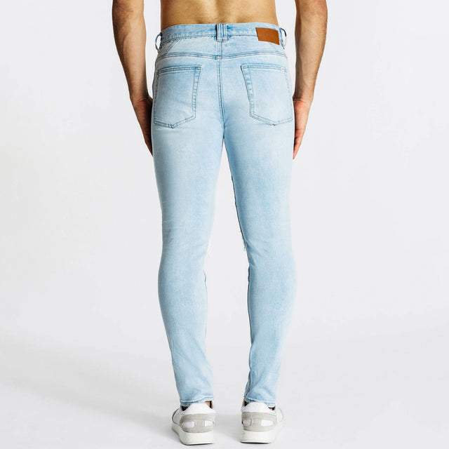 Model Wears Combination Jean 2.0 Canyon Blue Pants in Blue - Image 5