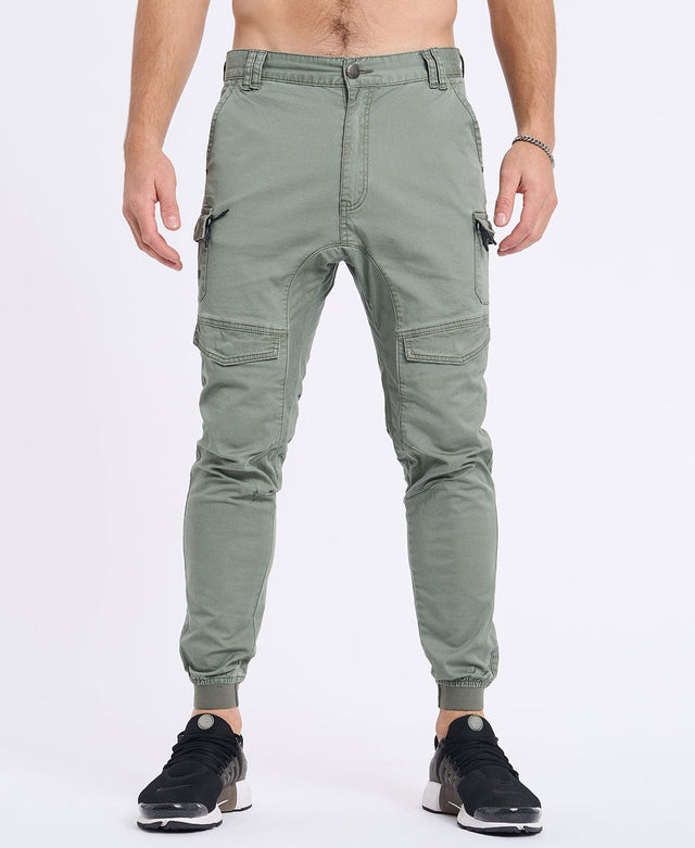Model Wears Flight 2.0 Pant Oil Green Pants in Green - Image 4