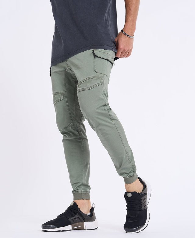Model Wears Flight 2.0 Pant Oil Green Pants in Green - Image 1