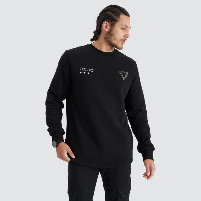 Model Wears Novice Dual Curved Sweater Jet Black Jumpers in Black - Image 1