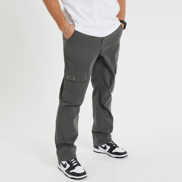 Model Wears Overland Cargo Pant Charcoal Pants in Grey - Image 1