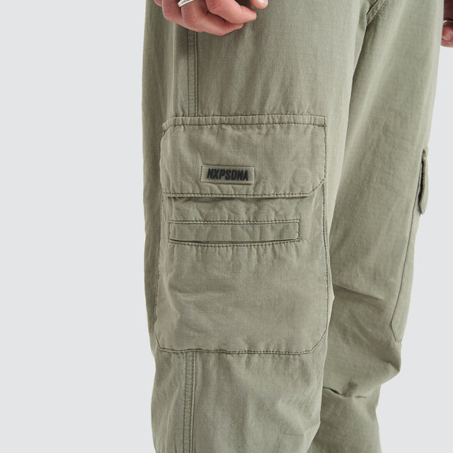 Model Wears Overland Cargo Pant Sage Pants in Green - Image 7