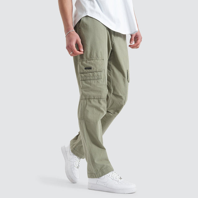 Model Wears Overland Cargo Pant Sage Pants in Green - Image 6