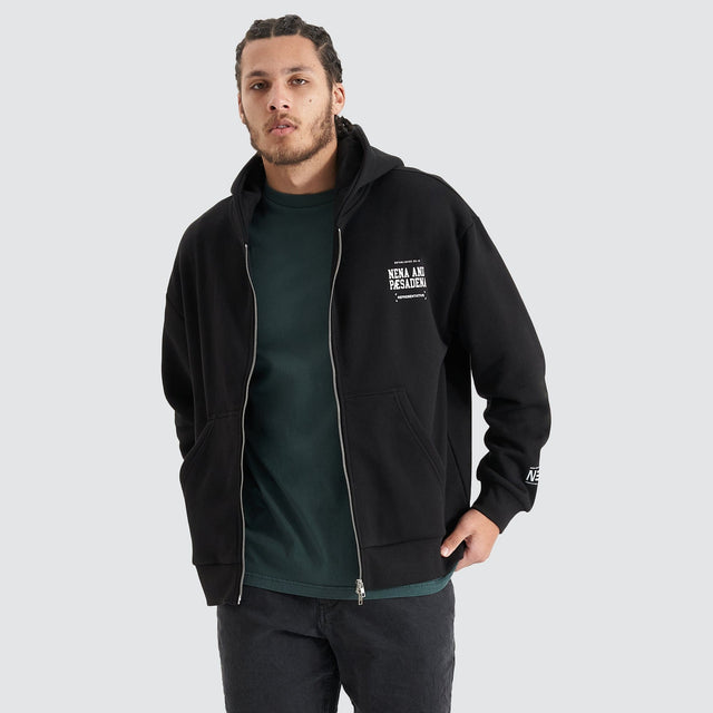 Model Wears Overtaking Relaxed Hooded Zip-up Jumper Jet Black Jumpers in Black - Image 1